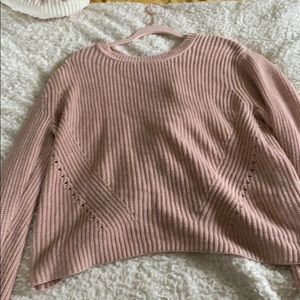 A light pink long sweater with a tie in the back
